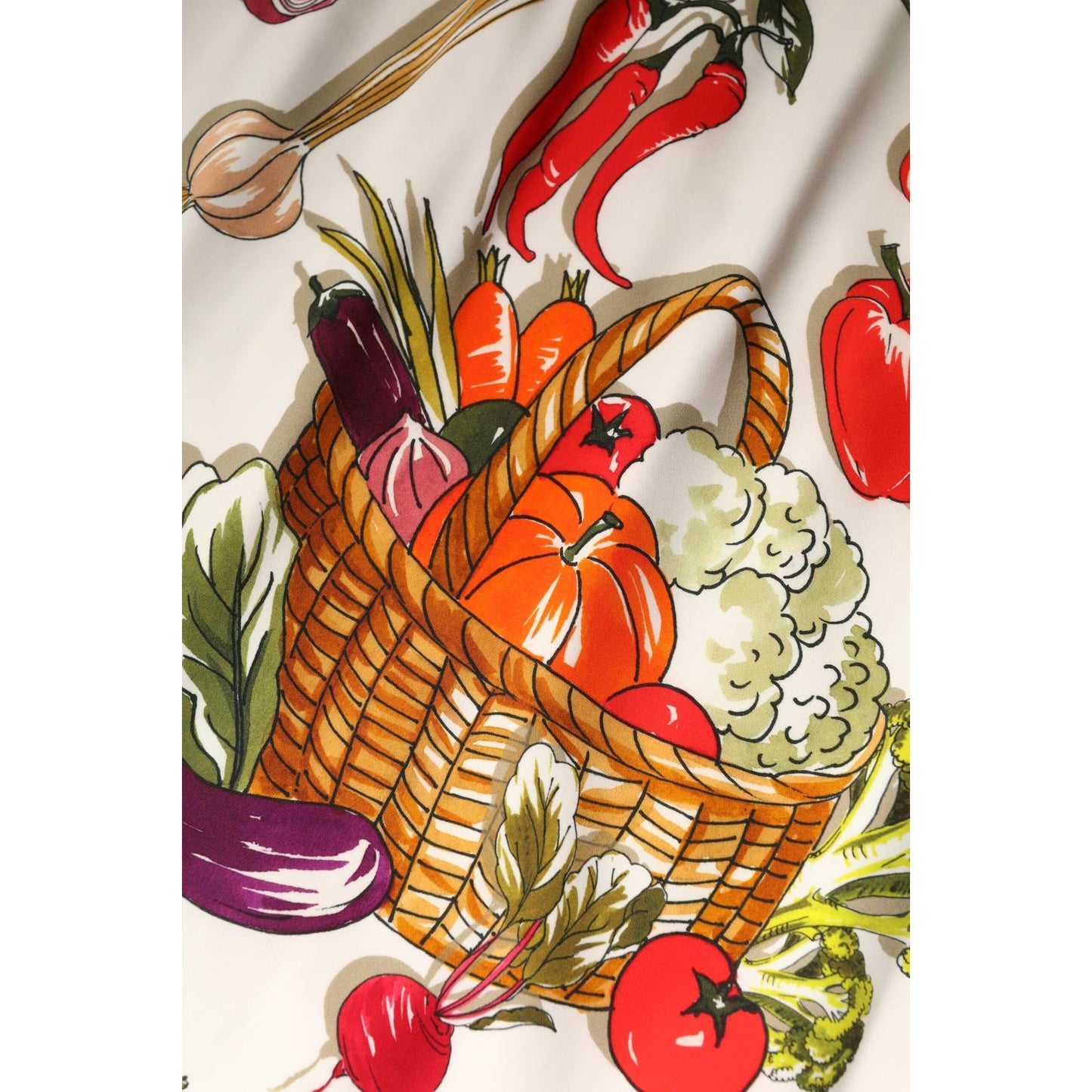 Dolce & Gabbana multicolor print close-up on skirt featuring basket of vegetables including peppers, eggplant, and radish.