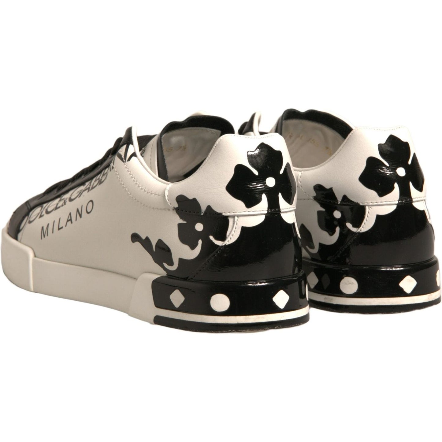 Dolce & Gabbana white and black leather sneakers with crown details, low-top design, logo accents, and rubber sole, made in Italy.