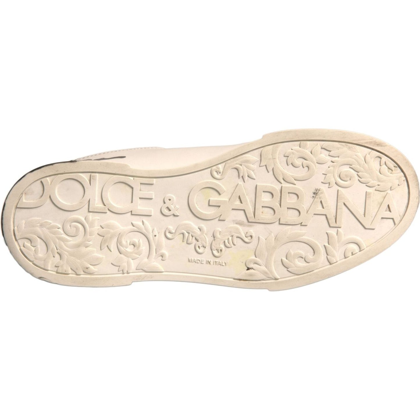 Sole of Dolce & Gabbana sneakers with embossed logo and floral pattern, made in Italy, showing high craftsmanship.