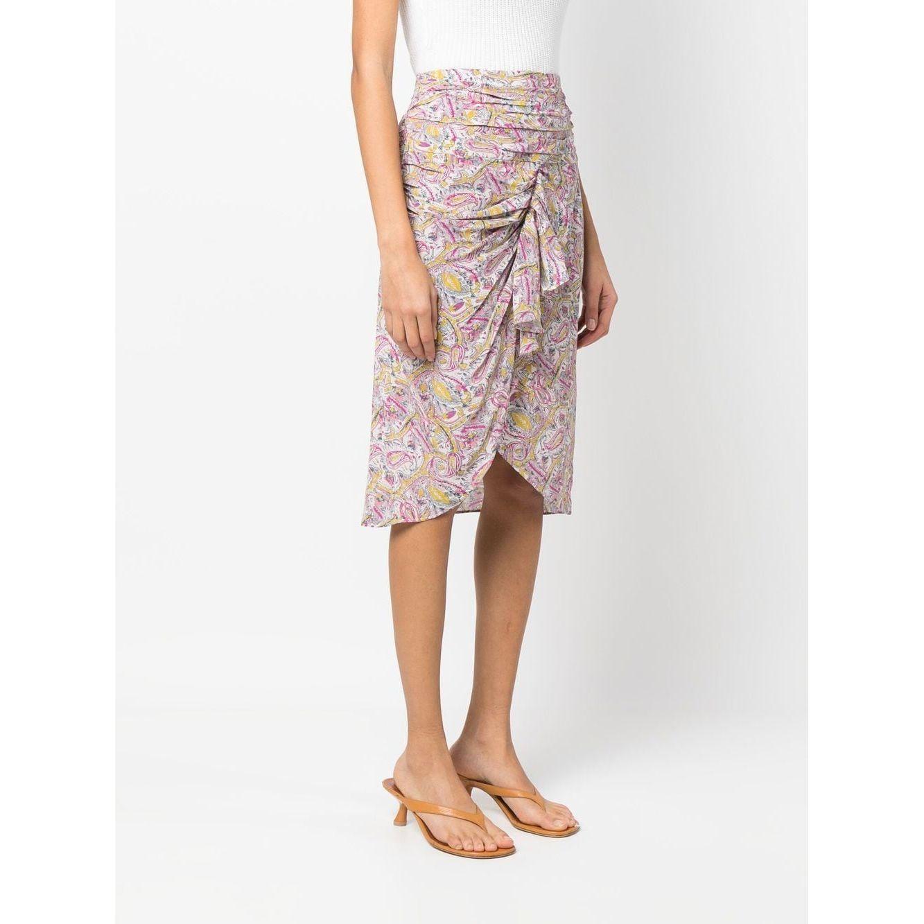 Graphic-print knee-length IRO skirt with ruching and draped detailing in ecru and pink silk, styled with high waist and matching sandals.