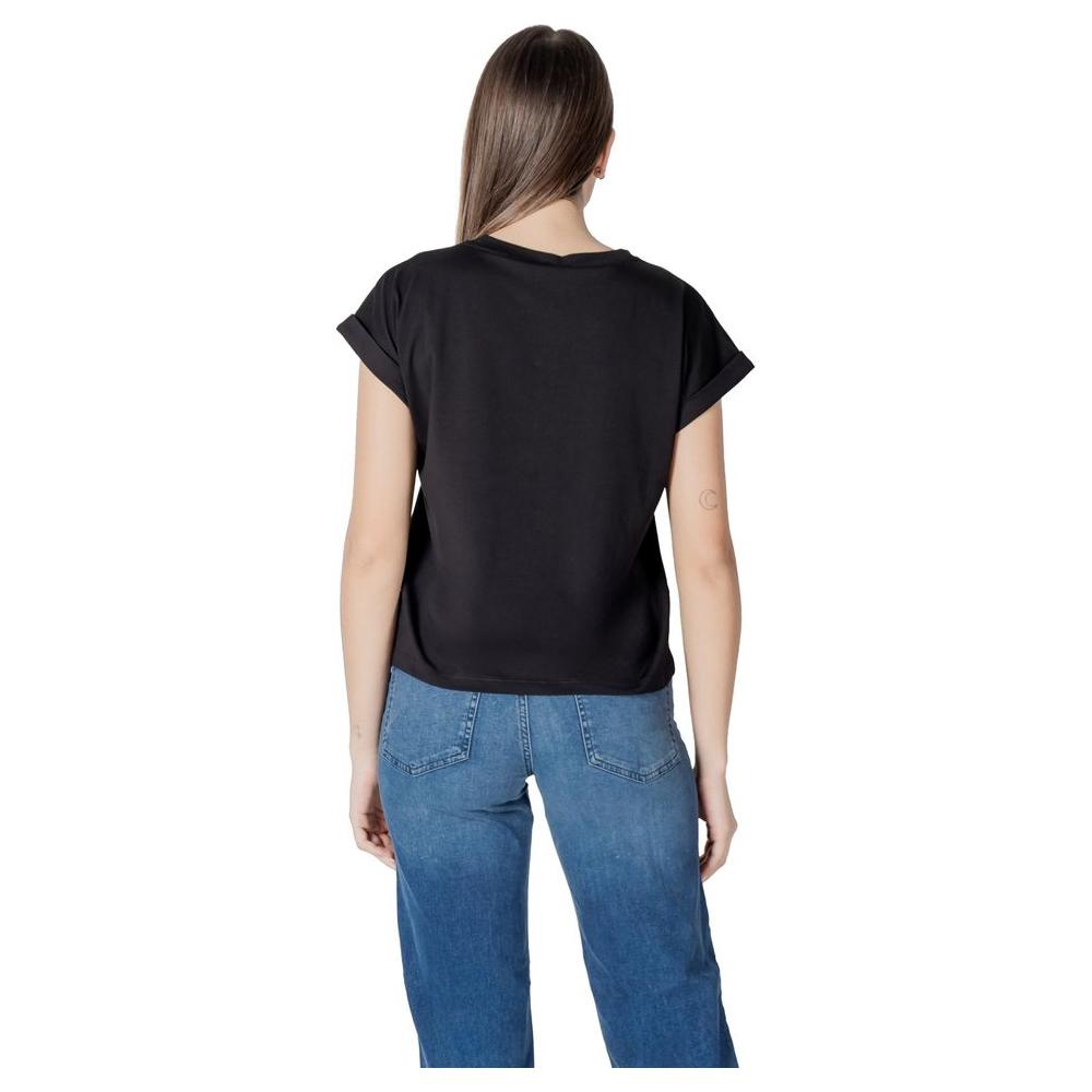 Back view of woman wearing Liu Jo black cotton short-sleeve t-shirt, paired with blue jeans for a casual look.