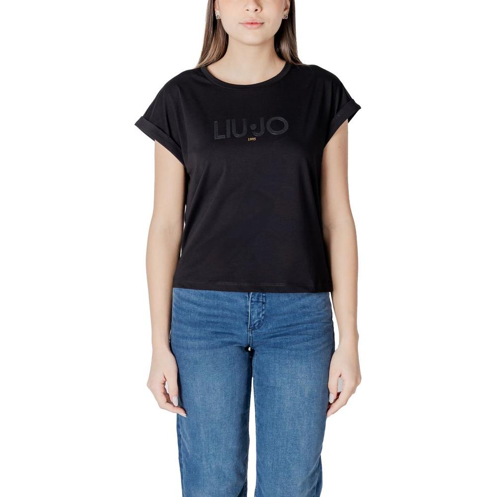 Woman wearing Liu Jo black cotton top with short sleeves, showcasing logo design, ideal for casual or elegant outfits, made of 95% cotton.