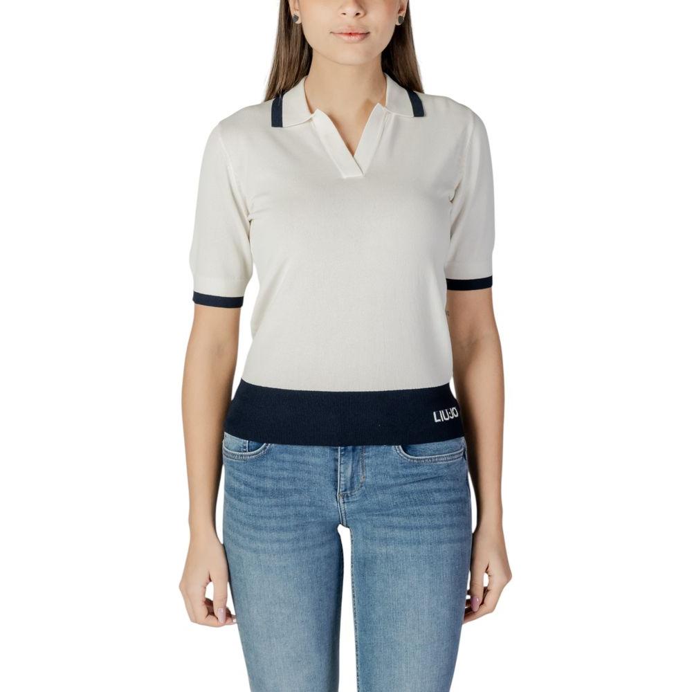 Woman wearing Liu Jo white viscose top with black accents, part of the spring/summer collection, paired with blue jeans.