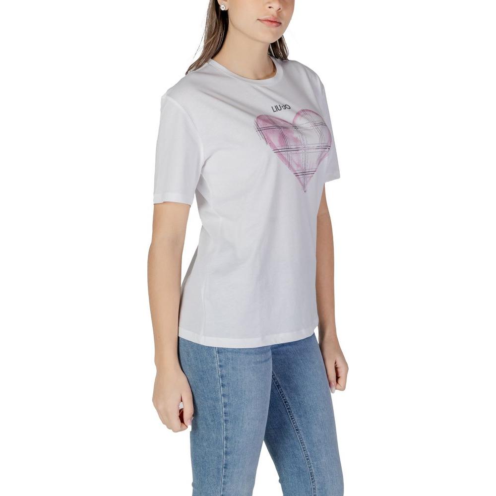 Woman wearing Liu Jo white cotton short-sleeved t-shirt with heart graphic, part of spring/summer women's collection.