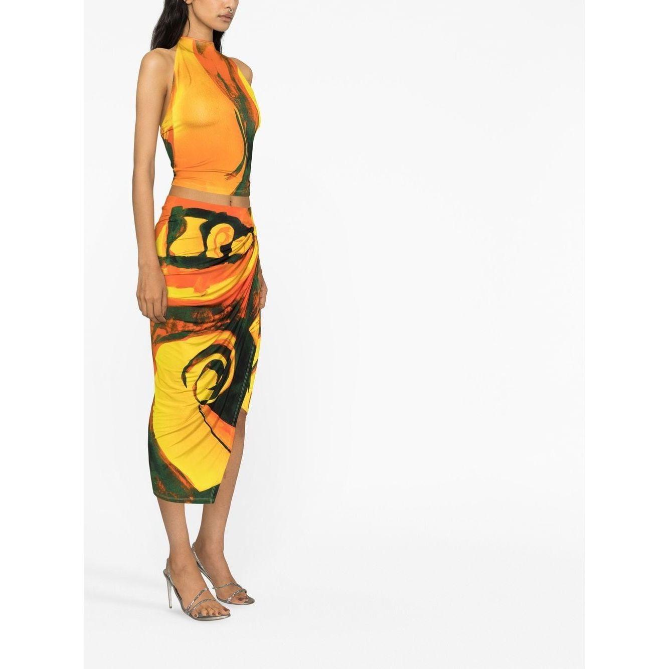 Model wearing Louisa Ballou multicolour coastline wrap skirt with abstract print, high-waist, ring hardware, and asymmetric design.