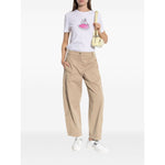 Woman wearing PS By Paul Smith T-shirts and Polos White, organic cotton t-shirt with poodle print, paired with beige pants and white sneakers.