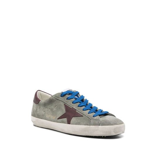 Golden Goose Super-Star sneakers in desert sage green with lace-up fastening, padded ankle, and rubber sole.