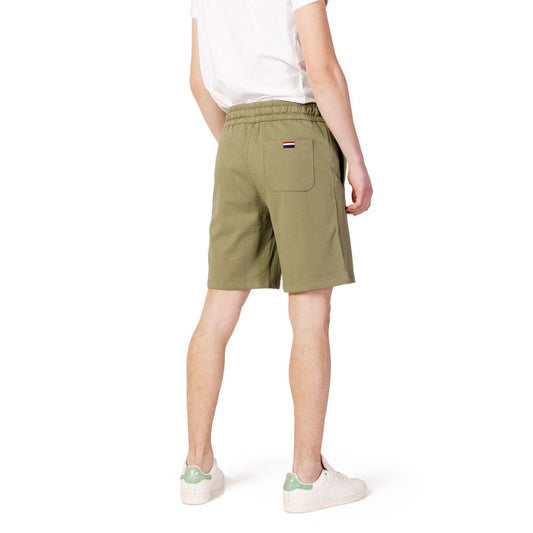 Back view of man wearing U.S. POLO ASSN. green cotton Bermuda shorts from the Spring/Summer collection, showcasing stylish casual wear.