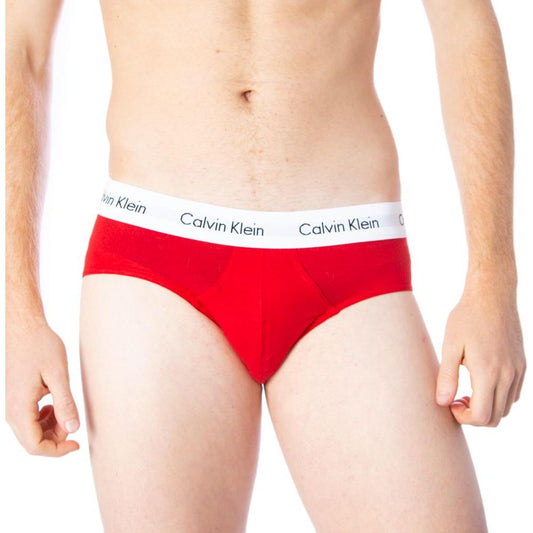 Man wearing Calvin Klein red cotton hip briefs with logo waistband for comfort and style.