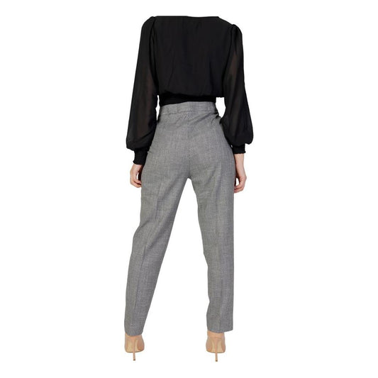 Back view of woman wearing Morgan De Toi black top and gray cigarette pants, spring/summer collection, polyester blend.