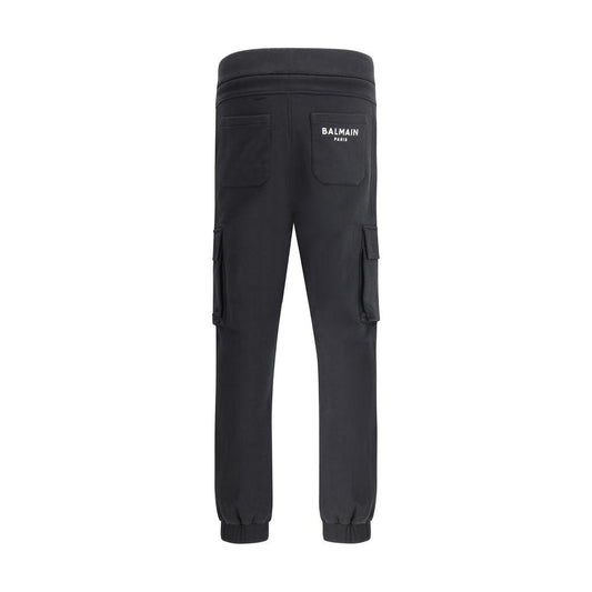Balmain cotton sweatpants with cargo pockets, elasticated waistband, and monochrome pattern, featuring iconic brand monogram on back.
