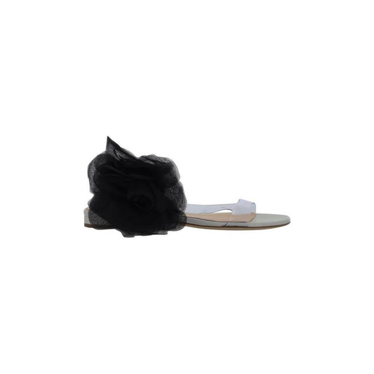 Magda Butrym sandals with transparent PVC design and black maxi flower appliqué, featuring a flat leather sole and logo-embossed insole.