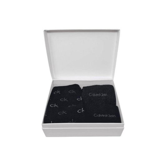 Calvin Klein black cotton tights and socks set in open white box, featuring logo and lurex details.