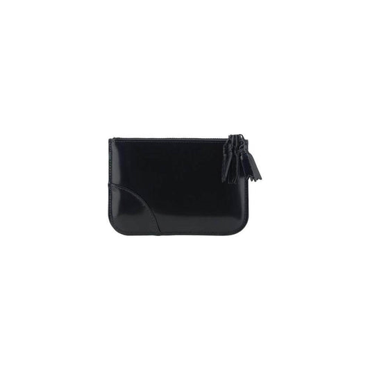 Comme des Garçons black leather coin purse with top zipper closure and signature logo, shiny finish.