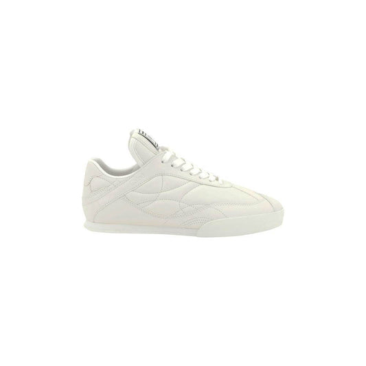 Chloé Leather Kick Sneakers with flat sole, lace-up closure, and logo patch. Elegant paneled design for versatile style and comfort.