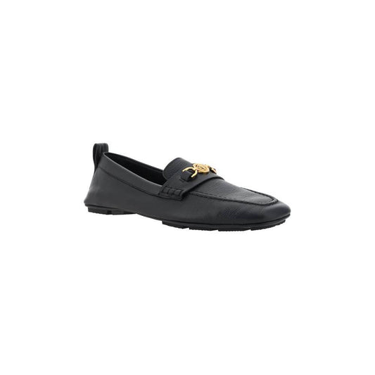 Black Versace leather driver loafers with metallic Medusa head and Greca motif, featuring hammered finish and injected sole.