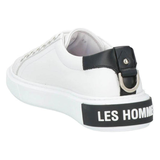 Les Hommes white calfskin men's sneaker with black heel counter, decorative metal ring, and embossed logo on white rubber sole.
