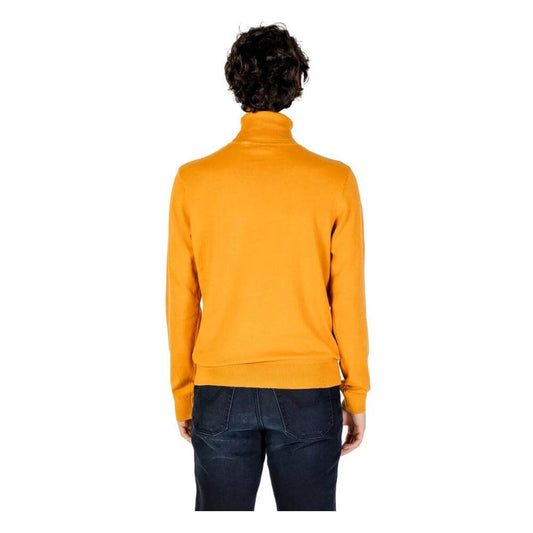 Back view of a men's orange cotton turtleneck sweater by U.S. Polo Assn., showcasing its elegant knitwear style.