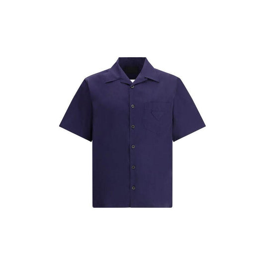 Prada short-sleeved cotton shirt with classic collar and front patch pocket, ideal for summer wear, showcasing the iconic brand patch