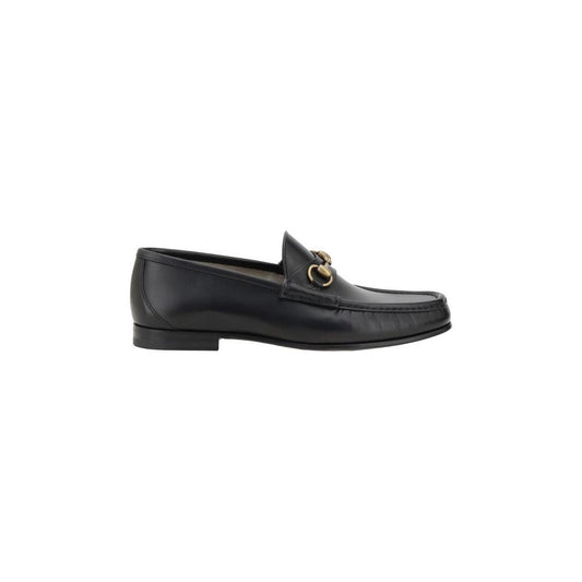 Gucci leather loafers with metallic horsebit detail, round toe, and leather block heel for chic sophistication.