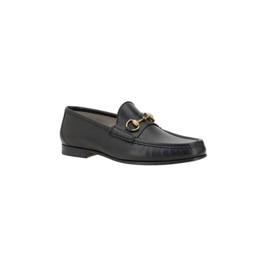 Gucci leather loafers with metallic horsebit detail, round toe, and leather block heel for elegant style and comfort.