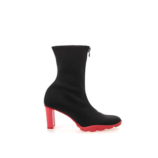 Alexander McQueen black neoprene boot with 10cm red heels, sock style, round toe, and zip fastening featuring rubber sneaker soles.