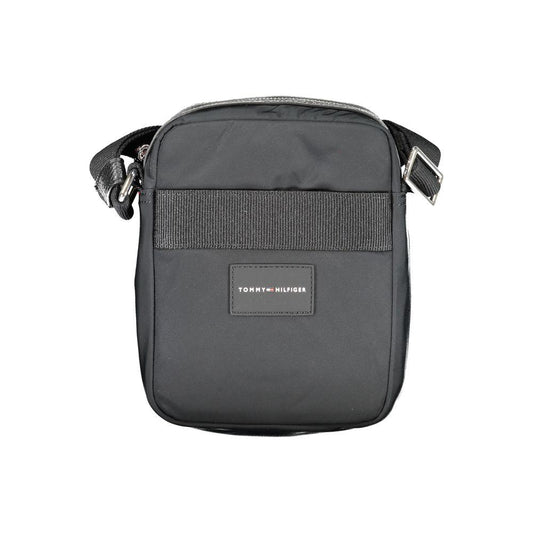Tommy Hilfiger black shoulder bag with adjustable strap, logo, external and internal pockets, zip closure, contrasting details.