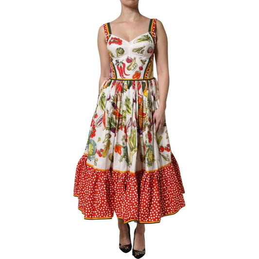 Dolce & Gabbana white sleeveless A-line midi dress with vegetable print and red polka dot trim, 100% cotton crafted, model posing.