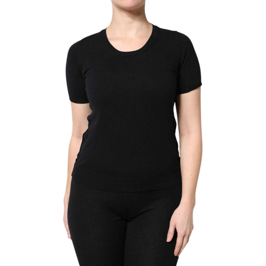 Woman wearing a Dolce & Gabbana black round neck short sleeve cotton t-shirt, highlighting luxury craftsmanship and Italian design.