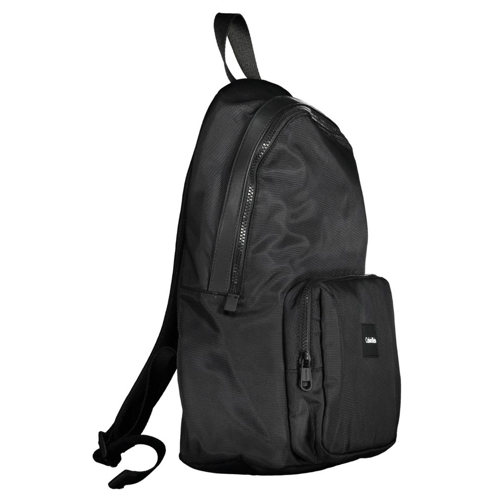 Calvin Klein Black Polyester Men Backpack with bold logo and eco-friendly design, perfect for urban trendsetters.