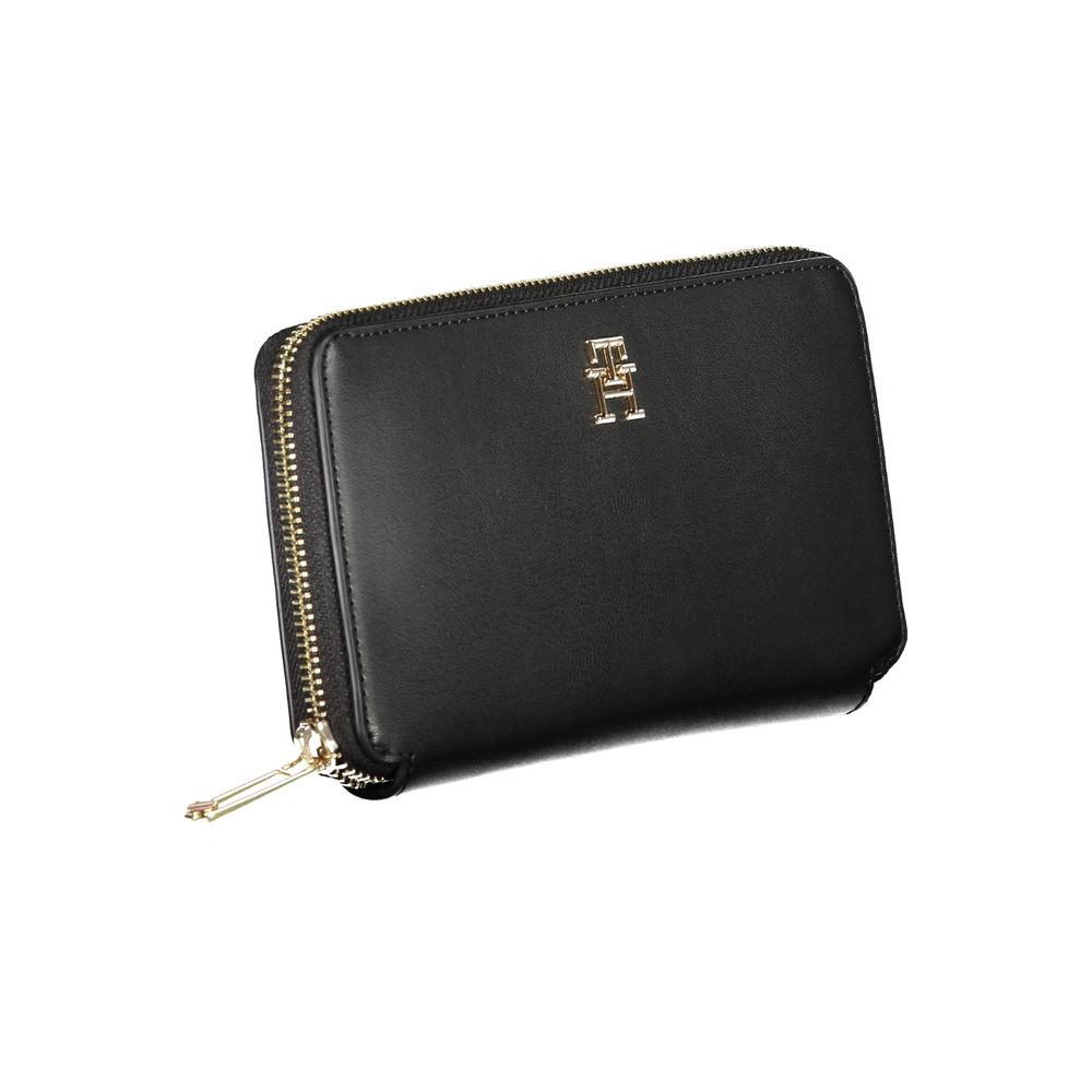Tommy Hilfiger Black Polyethylene Wallet with logo, zip closure, coin purse, and card spaces. Sleek design with multiple compartments.