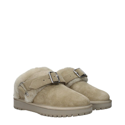 Beige suede slippers with buckle closure and fur detail, featuring a rubber sole and round toe design for casual wear.
