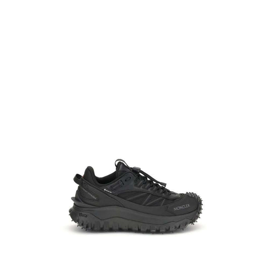 Moncler Black Calf Leather Bos Taurus Athletic Sneakers with reflective inserts and logo accents on black trail shoes.