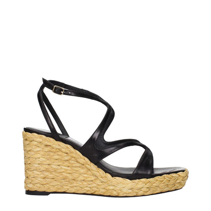 Jimmy Choo Black Leather Wedge Sandals with vintage effect, featuring a woven wedge heel and strappy design.
