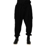 Dolce & Gabbana Black Cotton Blend Cargo Joggers Drawstring Pants with elastic waistband and side pockets, modeled. High-end streetwear style.