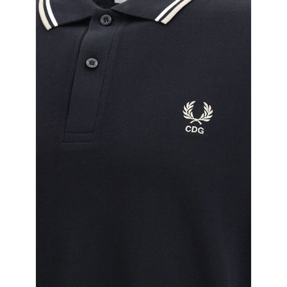 Comme Des Garçons Black Cotton Polo Shirt close-up with CDG emblem and white stripe detail on collar, featuring a bold yet classic style.