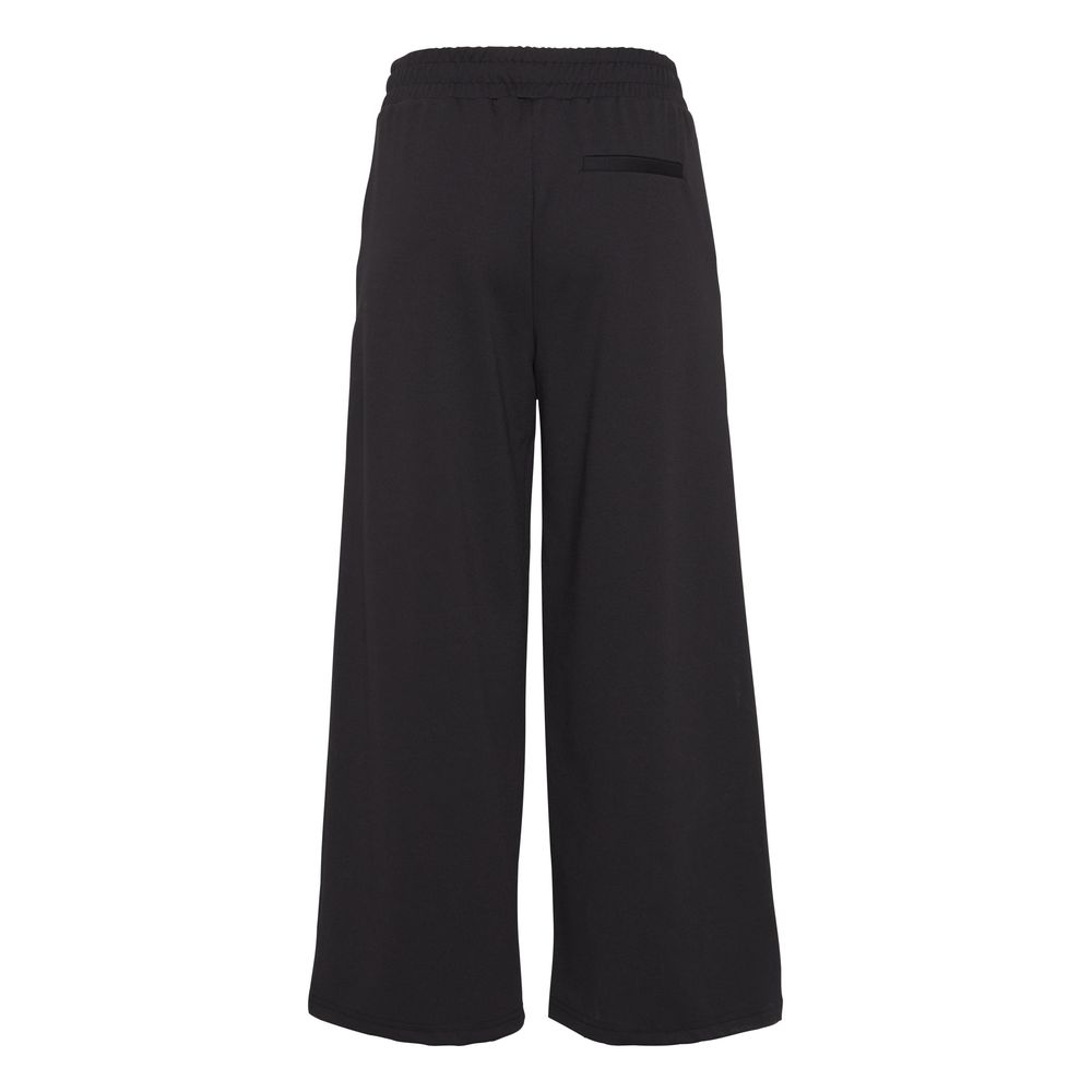 Rear view of ICHI Black Recycled Polyester Flared Pants with elastic waist, showcasing eco-friendly fashion with a modern silhouette.