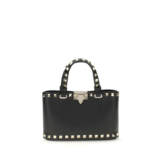 Valentino Garavani Mini Shopping Rockstud in grained calfskin with platinum-finished studs, handles, chain strap, and nappa lining.