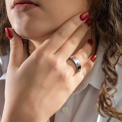 Close-up of a hand wearing AN JEWELS JEWELRY Mod. AL.RWH01SC-8 ring with red nails and white shirt sleeve.