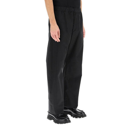 Alexander McQueen Black Cotton Casual Pants with elastic waist, side and back pockets, front zip, 100% cotton, made in Italy.