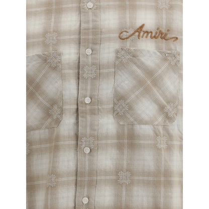 Amiri Beige Cotton Pattern Shirt featuring check flannel design, embroidered logo, and raw-cut hem for a contemporary look.