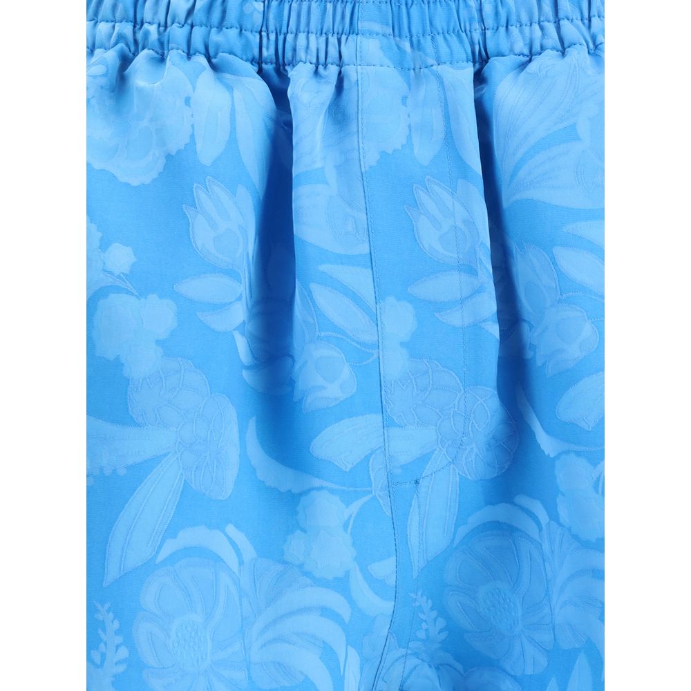 Close-up of Balenciaga Blue Viscose Bermuda Shorts with floral pattern and elastic waistband for a vibrant summer look.