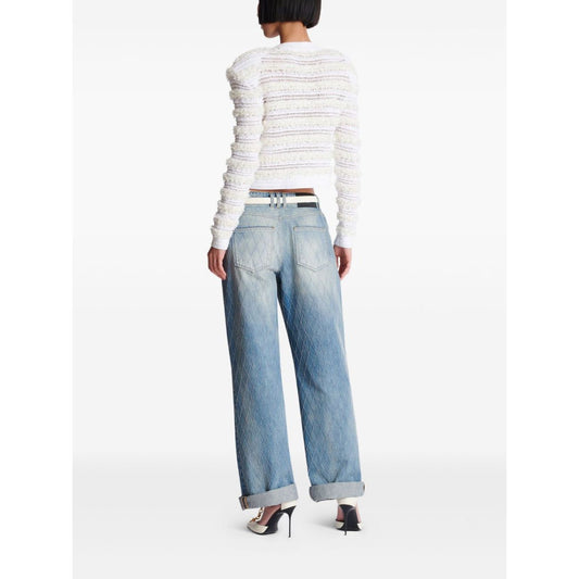 Model wearing Balmain Long-sleeved tweed-effect knit cardigan with white ribbed trim viewed from the back, paired with jeans.