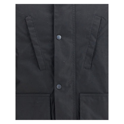 Close-up of Barbour International Black Cotton Parka showing front pocket details and button closure.