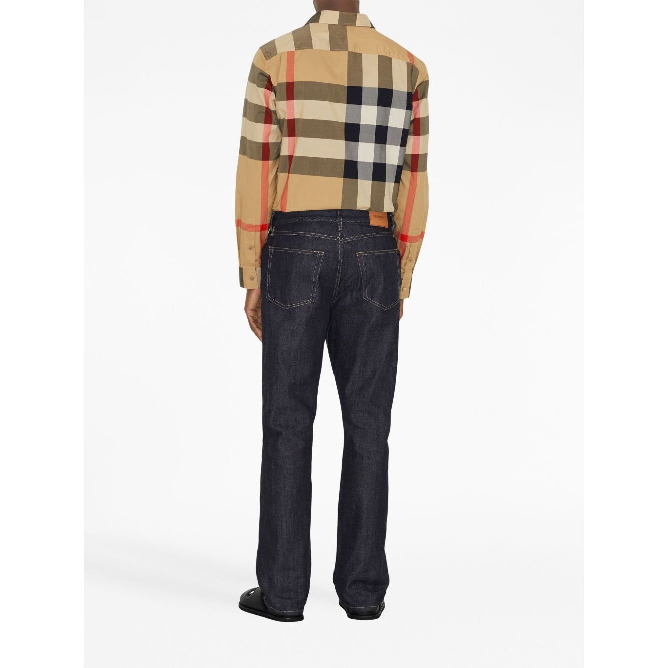 Back view of model wearing Burberry Check cotton shirt in archive beige with classic collar, check print, button-up, and curved hem.