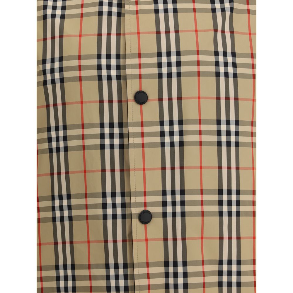 Close-up of Burberry Reversible waterproof Jacket featuring classic check pattern and button detail.