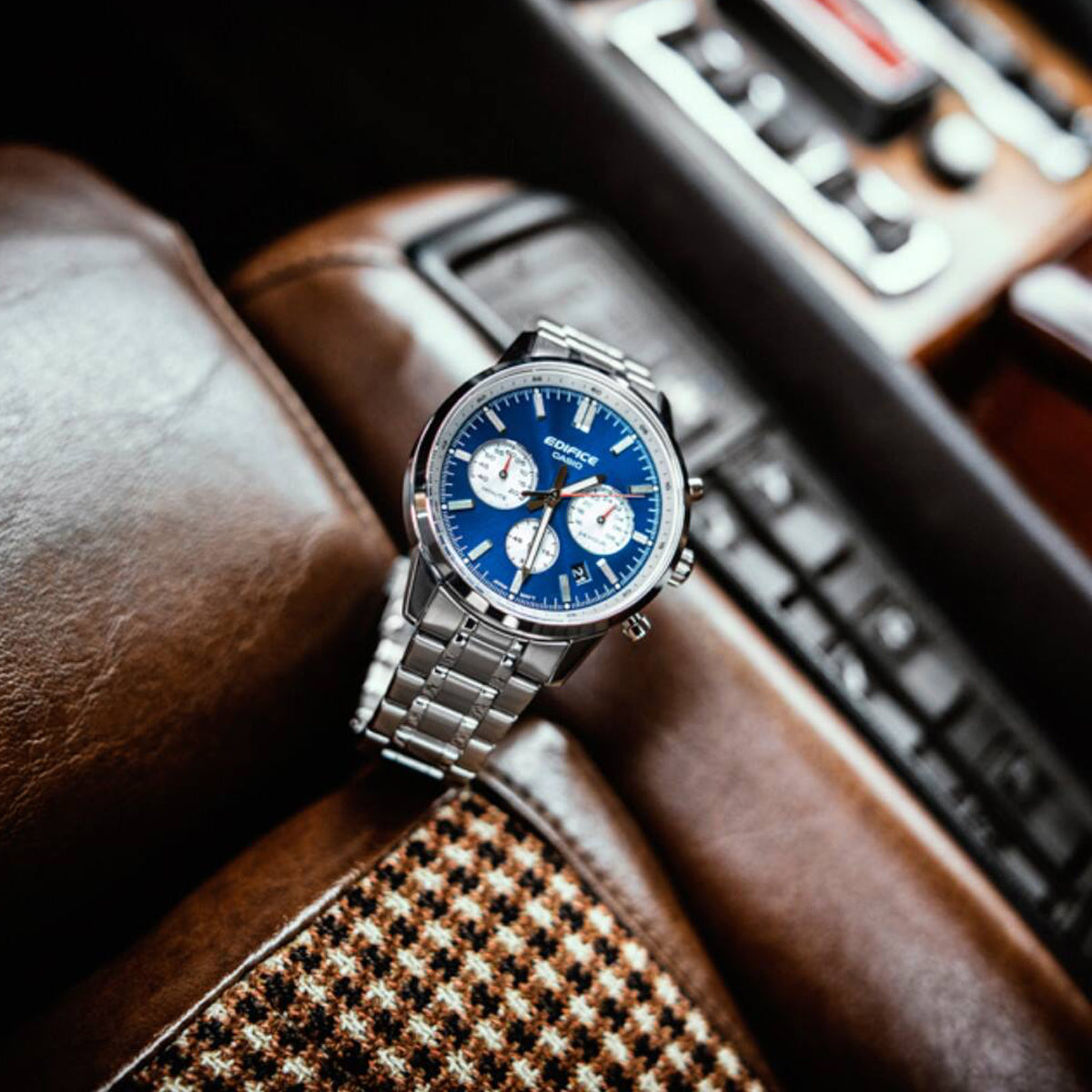 CASIO EDIFICE WATCHES Mod. EFR-575D-2AEF, stainless steel chronograph wristwatch with blue dial, on car seat