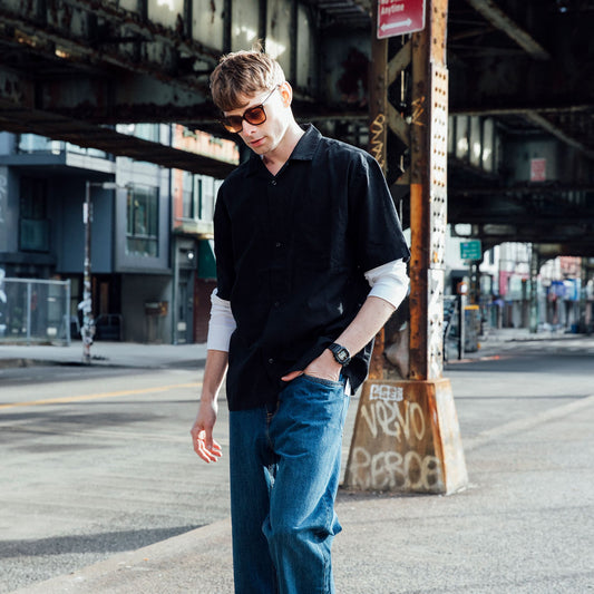 Fashion model wearing CASIO G-SHOCK Mod. THE ORIGIN - RE-EDITION SUPER ILLUMINATOR wristwatch in urban setting