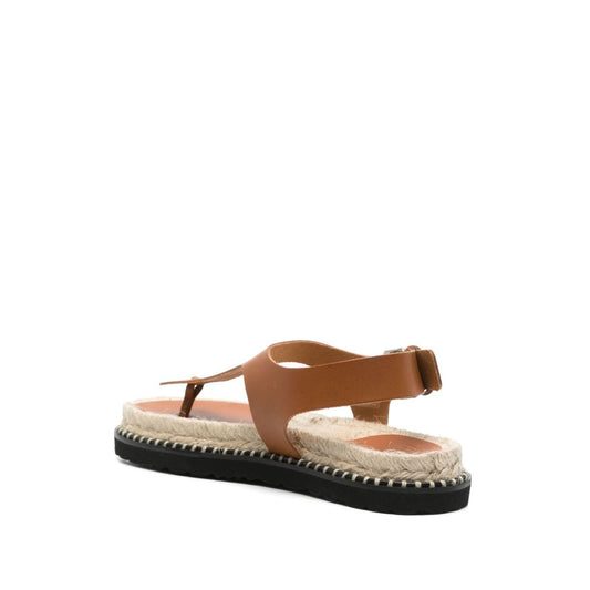 Castañer Castaner Sandals Leather Brown with flat rubber sole and buckle-fastening ankle strap, featuring a cognac brown leather design.