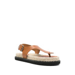 Castañer Castaner Sandals Leather Brown, cognac brown thong with buckle-fastening ankle strap and flat platform sole.